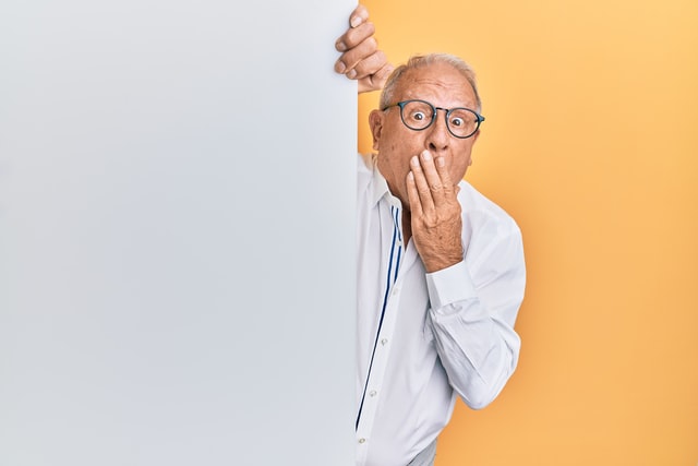 man peeking behind a wall