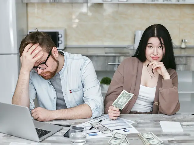 Worried couple with money