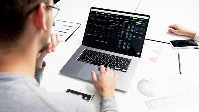 Alternatives to the Stock Market: Where Else to Invest Your Money 1 man in front of a laptop