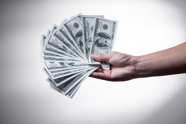 High Earner Not Rich Yet: How to Avoid Becoming a HENRY 1 holding $100 bills