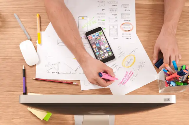 High Earner Not Rich Yet: How to Avoid Becoming a HENRY 4 messy desk and a man writing on paper