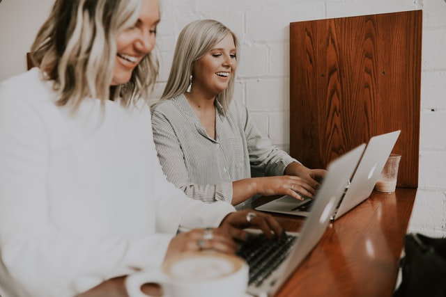 How to Make Money Blogging: My Best Tip 3 tow smiling women working on a laptops