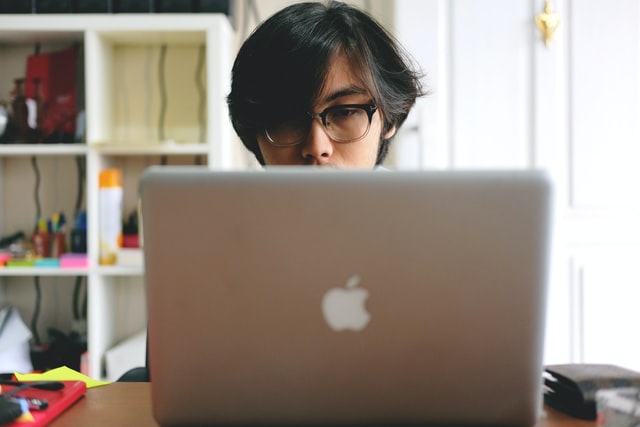 teen in front of a laptop