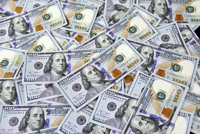 How to Become a Millionaire: 16 Tips to Follow 2 one hundred dollar bills