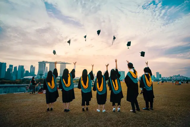 Graduates throwing their hats up in the air