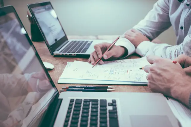 How To Transfer From Robinhood To Fidelity 2022 2 two man writing on a paper in front of two laptops
