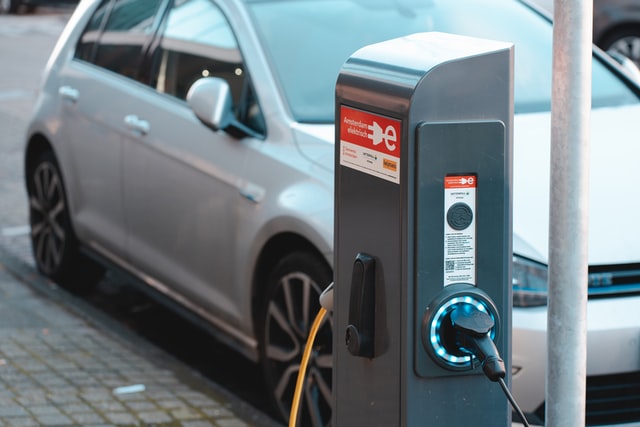 electric car next to a charging stand