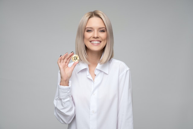woman holding bitcoin