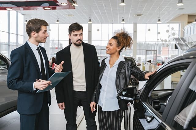 Should The Newly Engaged Own One Car Or Two When First Starting Out 1 Couple at the car dealer
