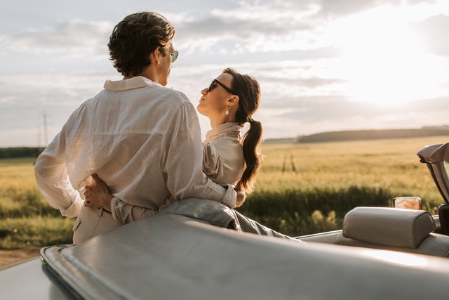 couple leaning on a car