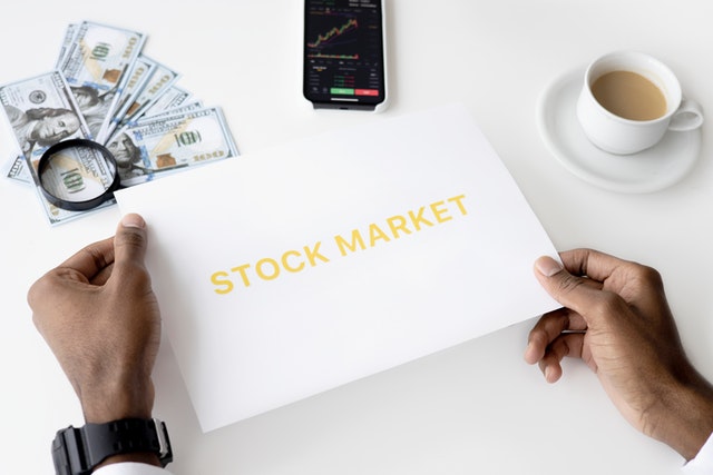 holding stock market sign