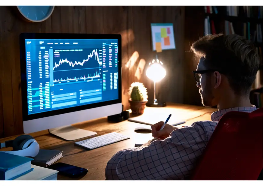 Man in front of a computer looking at а trading chart